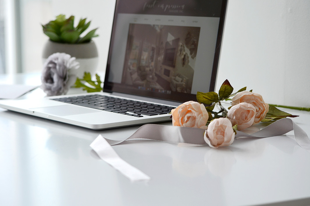 laptop and flowers on a table - White Canvas Design