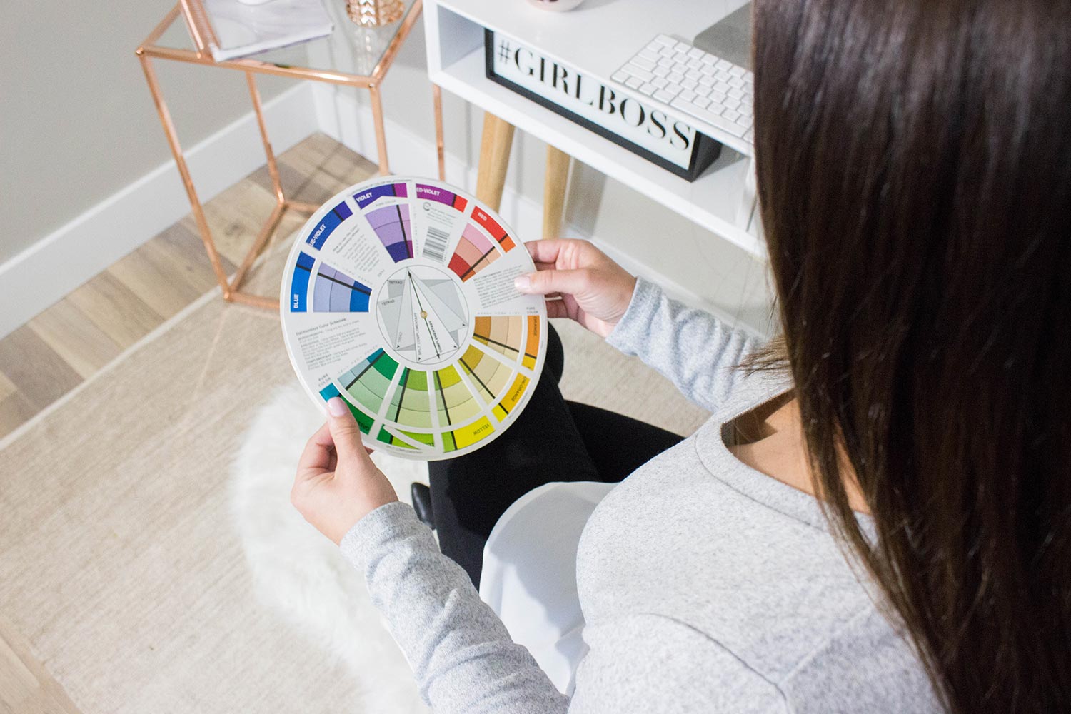 woman looking at a color wheel - White Canvas Design