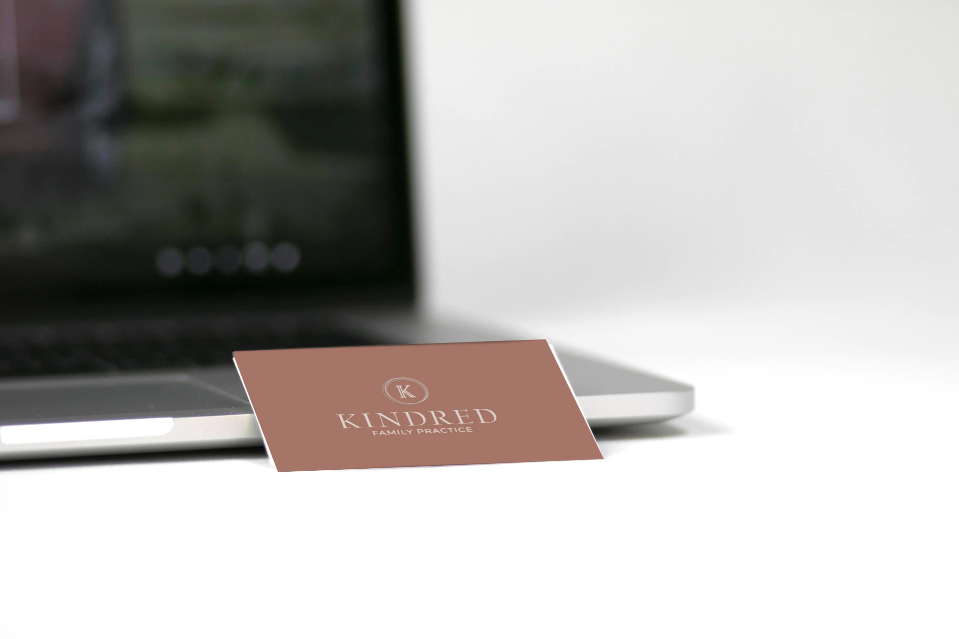 Kindred business card on top of a laptop - White Canvas Design