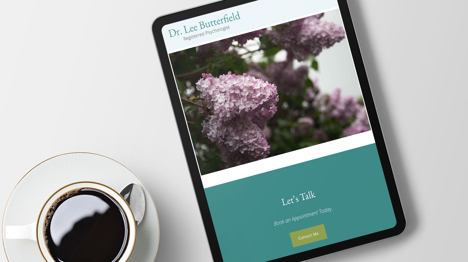 Dr. Lee Butterfield website shown on a tablet beside a cup of coffee - White Canvas Design