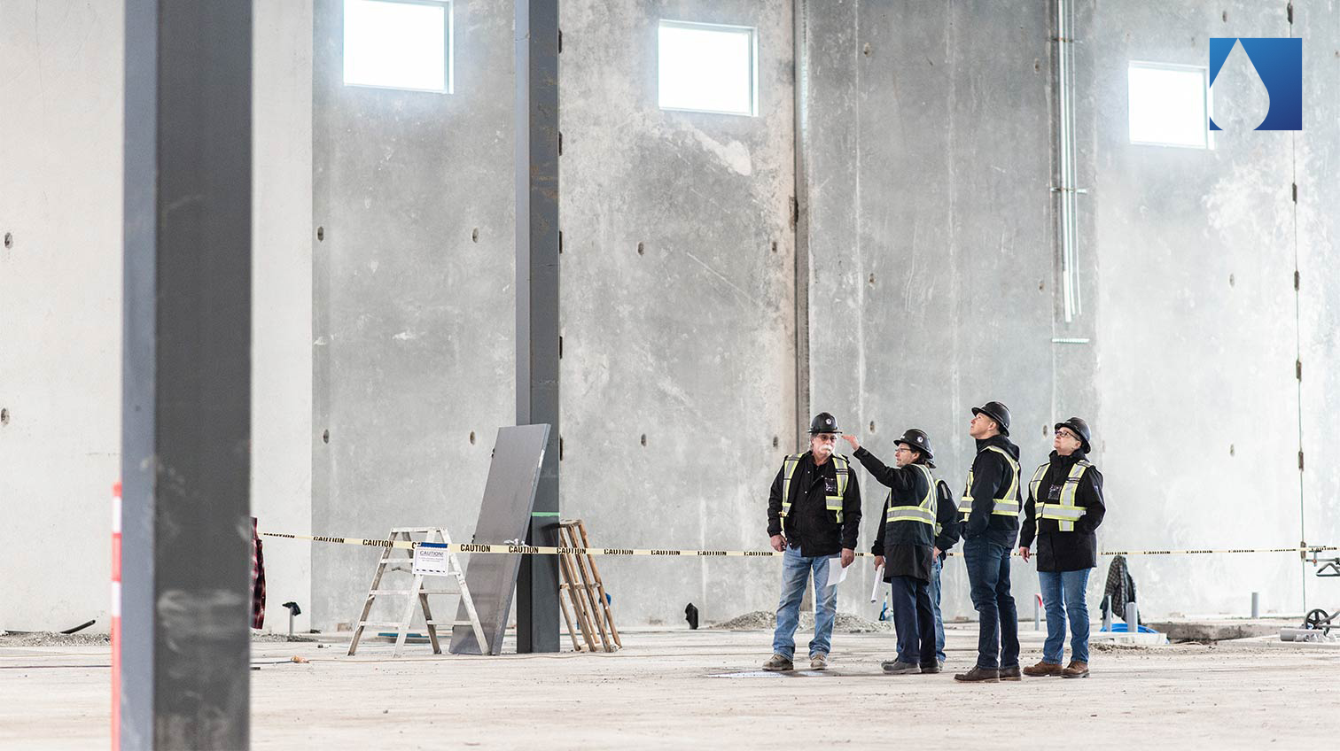 Rain City construction workers having a meeting inside an unfinished building- White Canvas Design