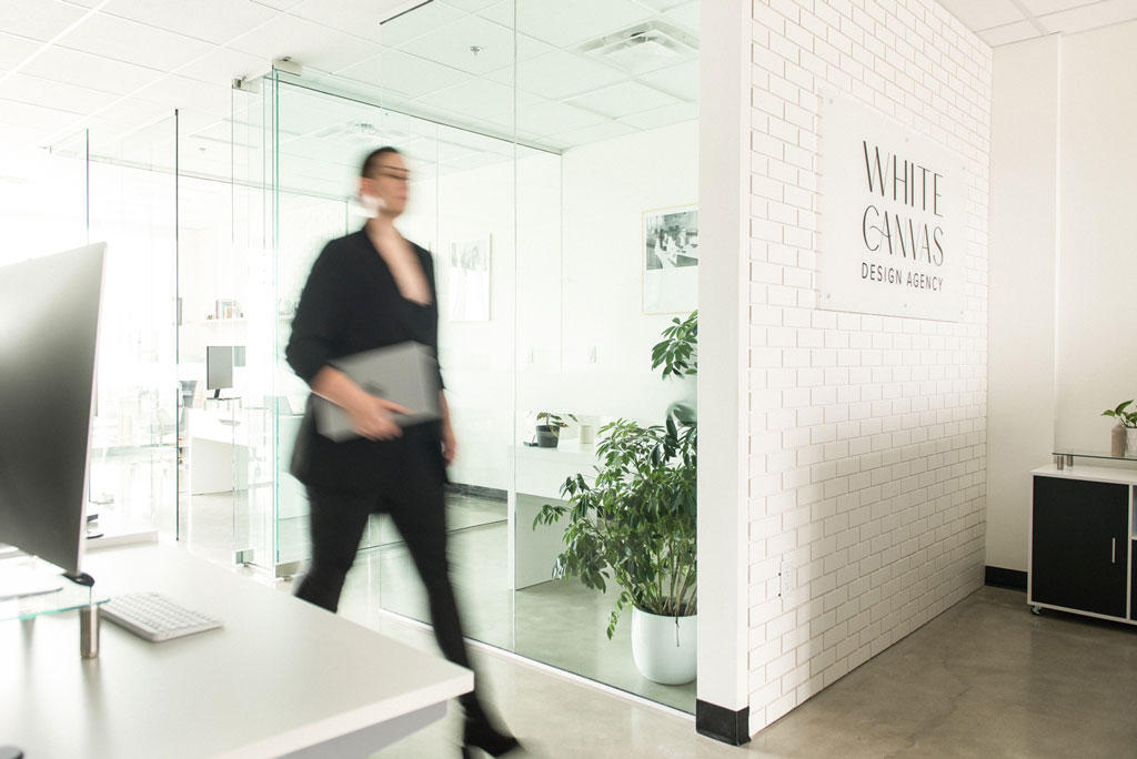 white canvas design agency team member walking by front desk