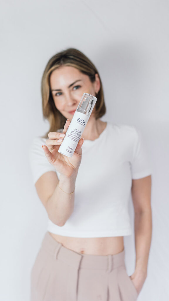 Tania holding a bottle of EOL product with the newly designed branding