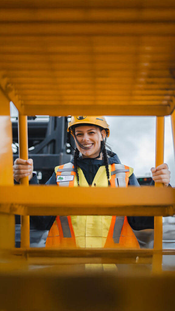 BCMEA crew member in safety gear posed behind a step ladder
