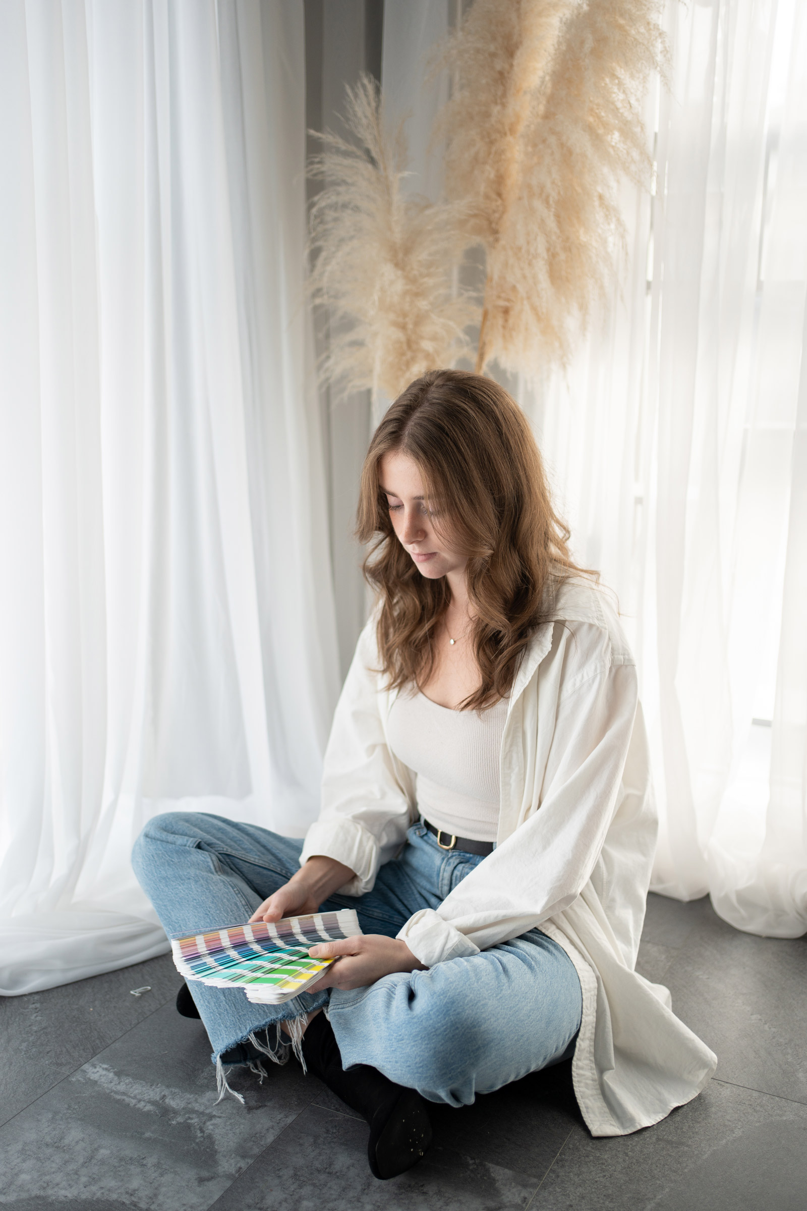 Cass searching for a colour in a Pantone swatch book