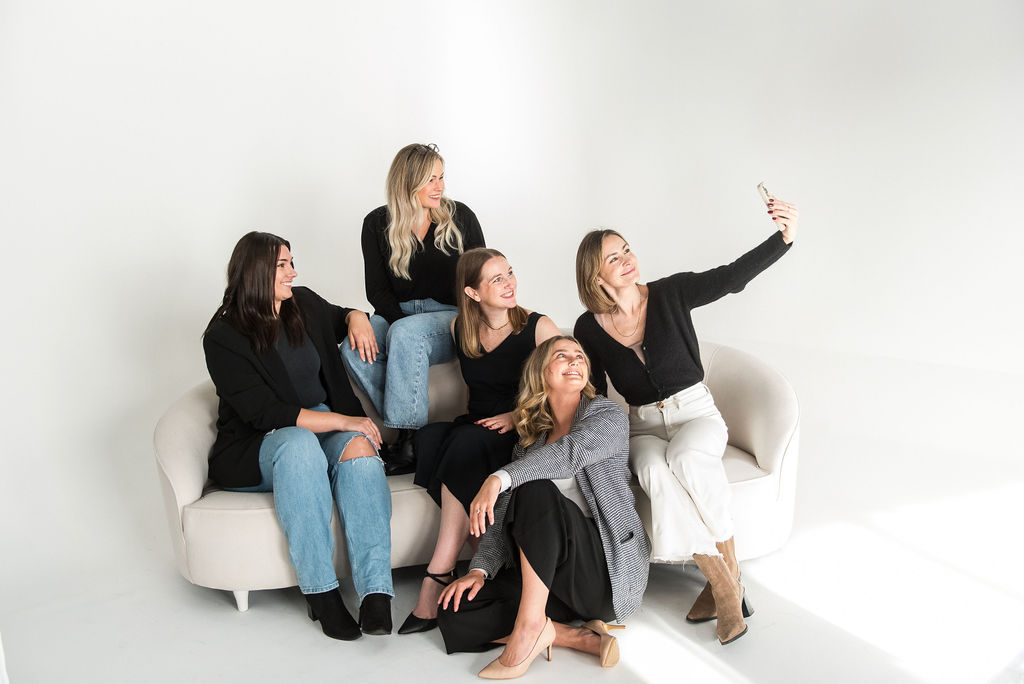 The five management team members sitting on a couch