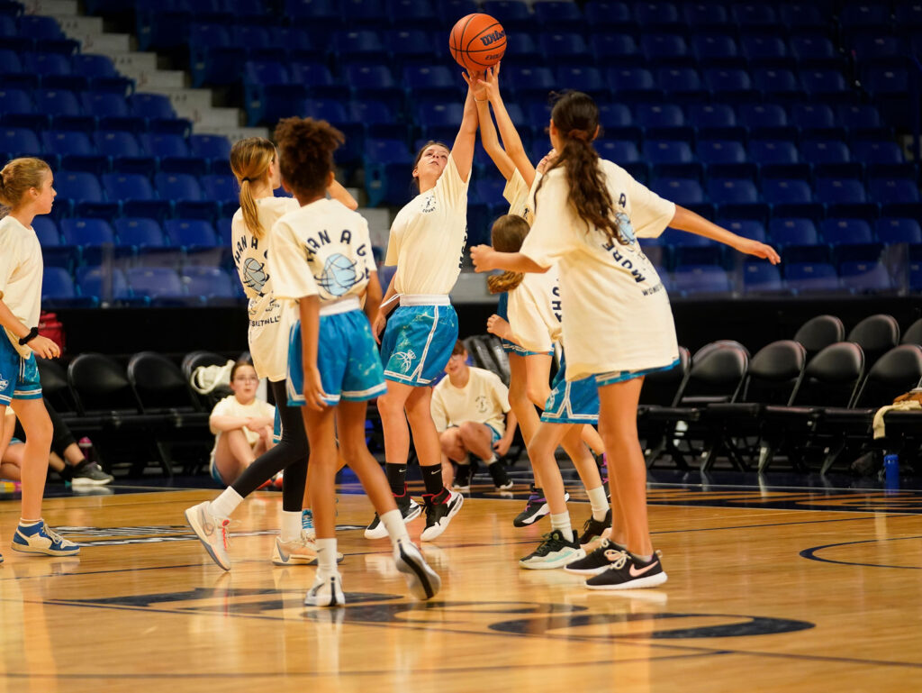A group of girls playing basket ball